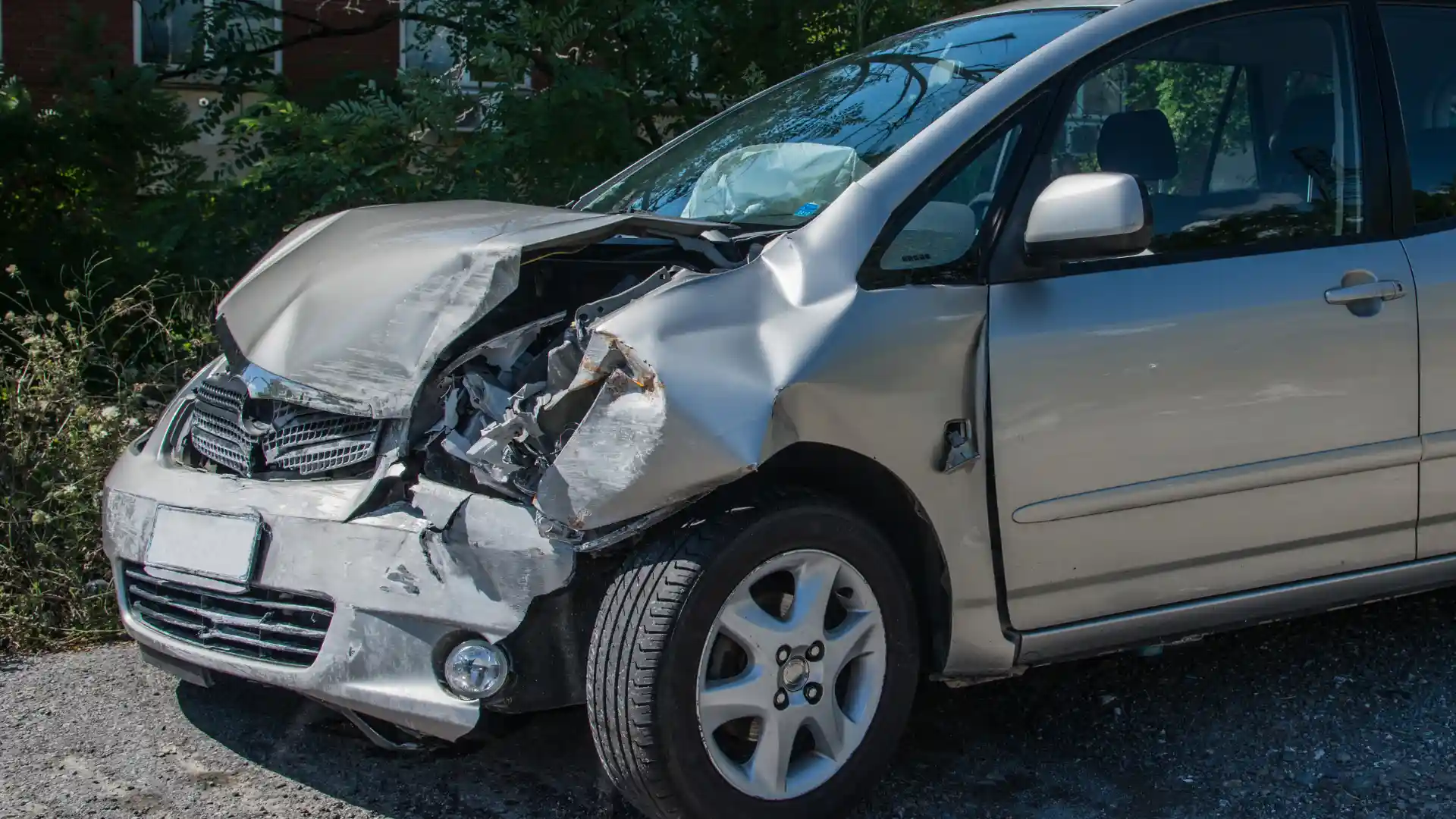 Car with severe front-end damage after an accident.