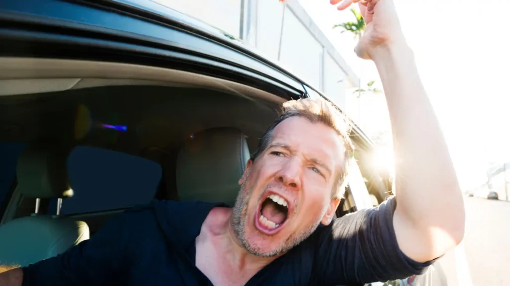 Driver expressing anger and yelling out of car window